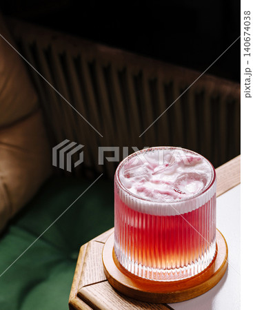 Pink refreshing cocktail with ice and foam Pink refreshing cocktail with ice and foam 140674038