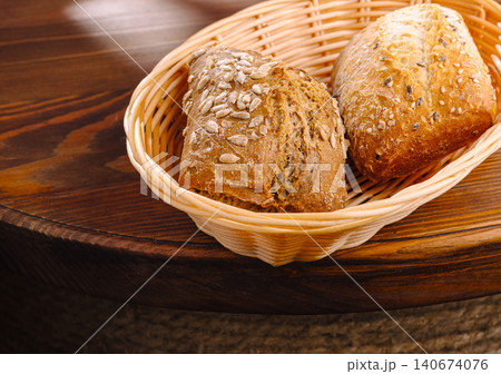 Fresh assorted buns in basket on wooden table 140674076
