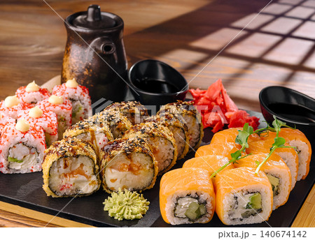 Assortment of sushi rolls with salmon, tempura, and tobiko Assortment of sushi rolls with salmon, tempura, and tobiko 140674142