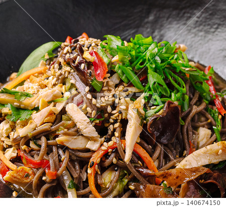 Asian soba noodle dish with chicken, vegetables, and sesame seeds Asian soba noodle dish with chicken, vegetables, and sesame seeds 140674150
