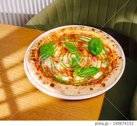 Neapolitan pizza with pesto, basil, mozzarella, and tomatoes Neapolitan pizza with pesto, basil, mozzarella, and tomatoes 140674152