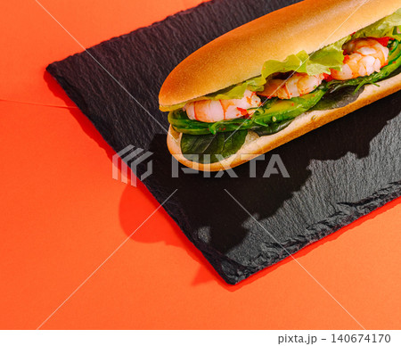 Shrimp sub sandwich with avocado on slate plate Shrimp sub sandwich with avocado on slate plate 140674170