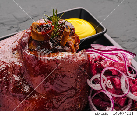Roasted pork knuckle with red cabbage and mustard Roasted pork knuckle with red cabbage and mustard 140674211