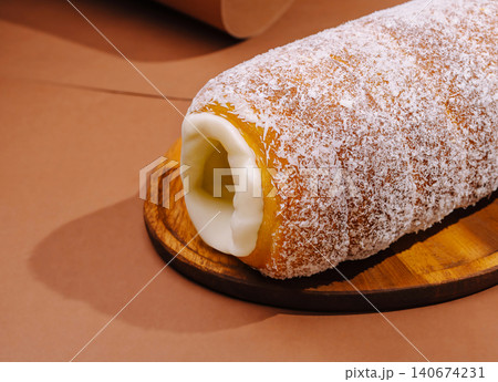 Trdelnik chimney cake with coconut and creamy filling 140674231