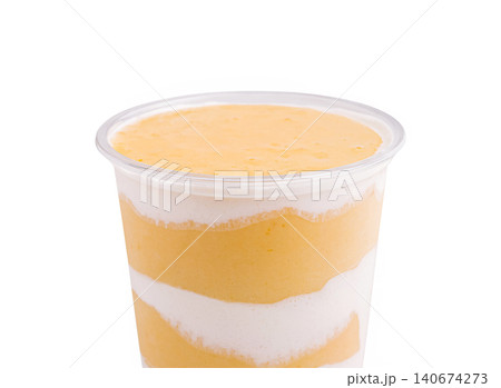 Layered mango yogurt smoothie drink in plastic cup Layered mango yogurt smoothie drink in plastic cup 140674273