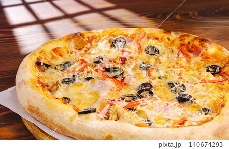 Freshly baked pizza with olives, bell peppers, cheese Freshly baked pizza with olives, bell peppers, cheese 140674293
