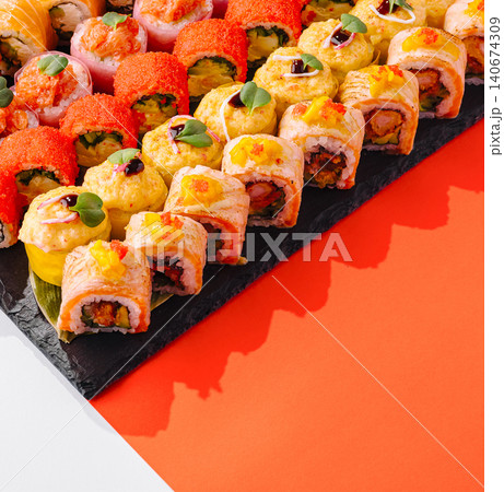 Assorted sushi rolls platter on black slate 140674309