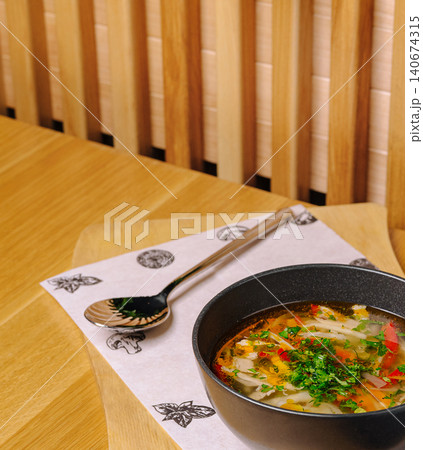 Chicken noodle soup with vegetables and herbs 140674315