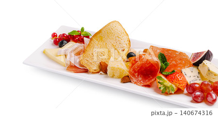 Charcuterie board with cheese, salami, and fresh fruit Charcuterie board with cheese, salami, and fresh fruit 140674316