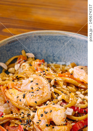 Shrimp noodles with vegetables, sesame, and peanuts in bowl Shrimp noodles with vegetables, sesame, and peanuts in bowl 140674357