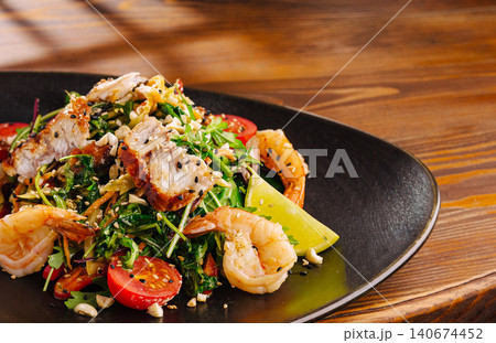 Gourmet seafood and chicken salad on wooden table Gourmet seafood and chicken salad on wooden table 140674452