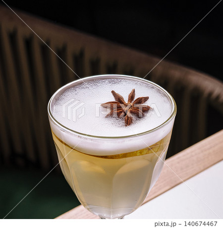 Cocktail with star anise garnish and pear slice Cocktail with star anise garnish and pear slice 140674467