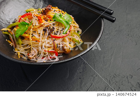 Glass noodle funchose salad with vegetables and chopsticks 140674524