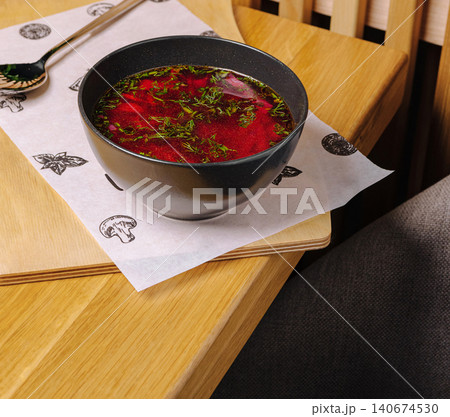 Borscht soup served on a wooden table for lunch Borscht soup served on a wooden table for lunch 140674530