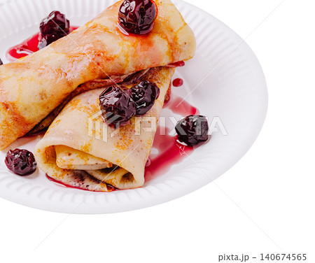 Golden crepes with cherry jam on white plate Golden crepes with cherry jam on white plate 140674565