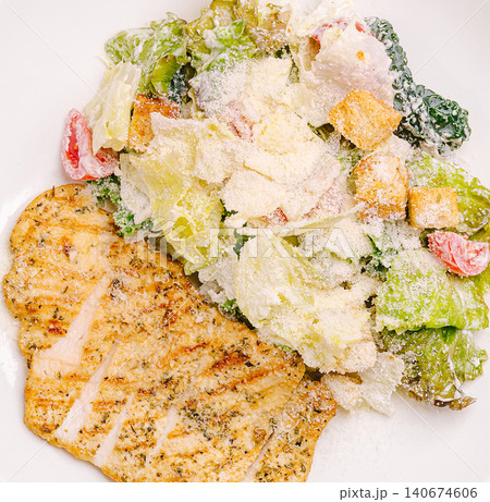 Grilled chicken caesar salad with parmesan cheese Grilled chicken caesar salad with parmesan cheese 140674606