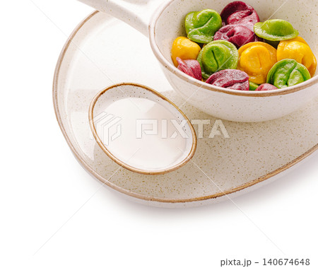 Colorful dumplings with sour cream dipping sauce on plate Colorful dumplings with sour cream dipping sauce on plate 140674648