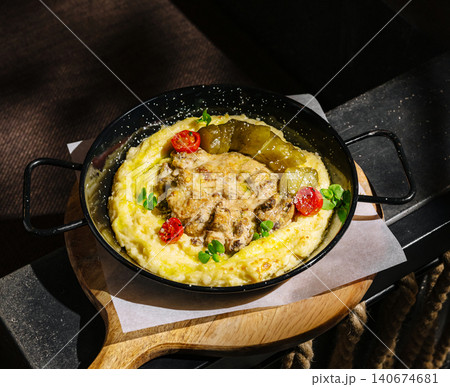 Beef stroganoff with mashed potatoes and pickles in skillet 140674681