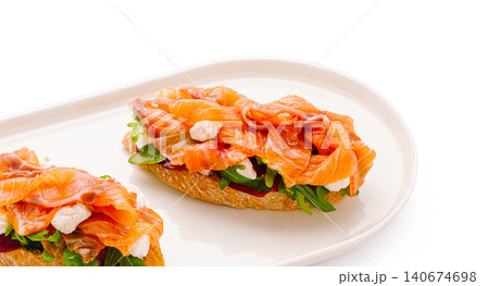 Smoked salmon bruschetta with cream cheese and arugula Smoked salmon bruschetta with cream cheese and arugula 140674698