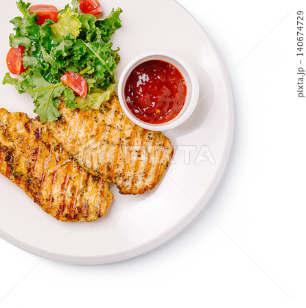 Grilled chicken breast with fresh green salad and sauce Grilled chicken breast with fresh green salad and sauce 140674729