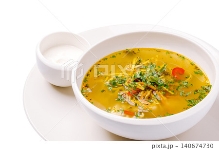 Chicken noodle soup with fresh herbs and sour cream 140674730