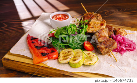 Grilled meat skewers with vegetables and salad Grilled meat skewers with vegetables and salad 140674735