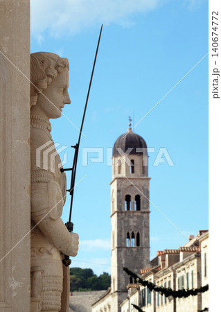 Orlando's Column, oldest preserved secular sculpture in Dubrovnik, Croatia. Franciscan church in the background. 140674772