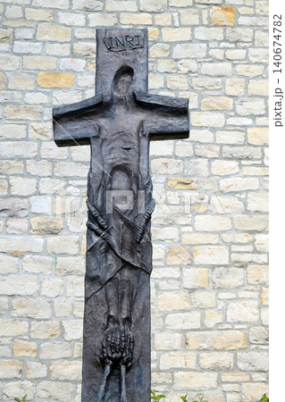 Cross by Sieger Koder in front the Church of Saint Bartholomew in Leutershausen, Germany Cross by Sieger Koder in front the Church of Saint Bartholomew in Leutershausen, Germany 140674782