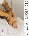 Close up of foot massage therapy session. Female massage therapist's hands. 140674910