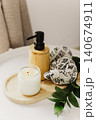 Still life of luxury spa essentials. A bottle with a massage oil and candle on a table. 140674911