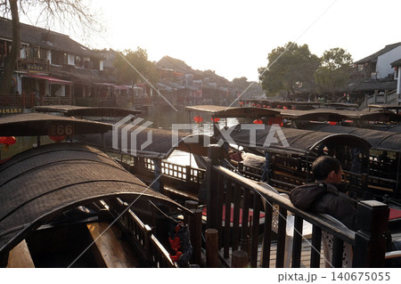 Tourist boats on the water canals of Xitang Town in Zhejiang Province, China Tourist boats on the water canals of Xitang Town in Zhejiang Province, China 140675055