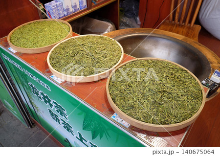 Various types of tea in wooden bowls exposed for sale in a Chinese tea shop in Hangzhou, China 140675064