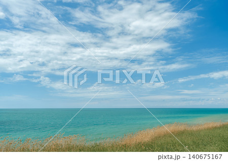 Panorama of a calm sea in clear weather, copy space for text about vacation and active travel along popular routes and trails Panorama of a calm sea in clear weather, copy space for text about vacation and active travel along popular routes and trails 140675167