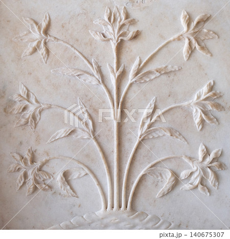 Mughal stone art on the facade of the Taj Mahal (Crown of Palaces), an ivory-white marble mausoleum in Agra, Uttar Pradesh, India Mughal stone art on the facade of the Taj Mahal (Crown of Palaces), an ivory-white marble mausoleum in Agra, Uttar Pradesh, India 140675307