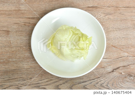 Iceberg or crisphead lettuce fresh vegetable salad on plate Iceberg or crisphead lettuce fresh vegetable salad on plate 140675404