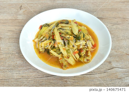 spicy stir fried bamboo shoot with mussel couple basil in curry sauce on plate spicy stir fried bamboo shoot with mussel couple basil in curry sauce on plate 140675471