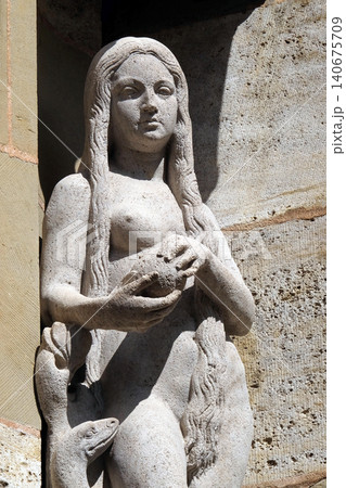 Eve with snake, statue on facade of the St James Church in Rothenburg ob der Tauber, Germany Eve with snake, statue on facade of the St James Church in Rothenburg ob der Tauber, Germany 140675709