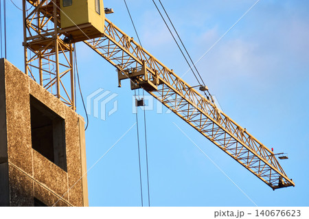 Tower crane cabin and mast at a high-rise building site Tower crane cabin and mast at a high-rise building site 140676623