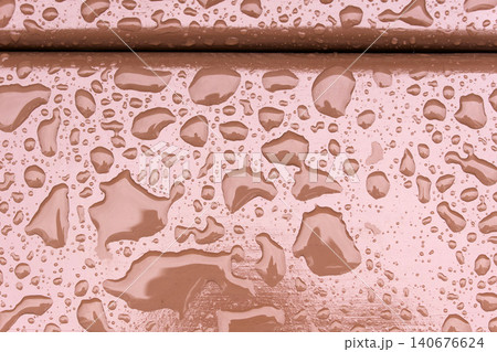 Water droplets on a wooden surface after rain at a park during the afternoon hours in early autumn 140676624
