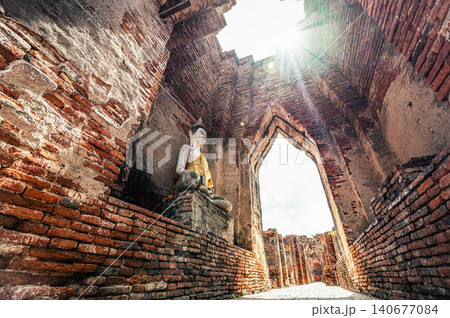 Majestic Sunbeam Shining on Ancient Buddha Statue Inside Prasat Nakhon Luang Ruins, Ayutthaya, Thailand Majestic Sunbeam Shining on Ancient Buddha Statue Inside Prasat Nakhon Luang Ruins, Ayutthaya, Thailand 140677084