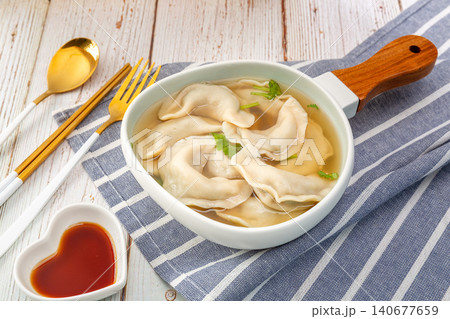 Traditional Chinese Suantang Shuijiao, Dumpling Soup with Vinegar and Chili Oil Traditional Chinese Suantang Shuijiao, Dumpling Soup with Vinegar and Chili Oil 140677659