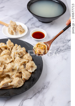 Traditional Chinese dumplings Jiaozi with pork and sauerkraut filling served with dipping sauce 140677713