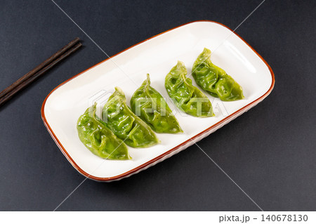 steamed Green Spinach Vegetable Dumplings on a Plate, Healthy Dim Sum steamed Green Spinach Vegetable Dumplings on a Plate, Healthy Dim Sum 140678130
