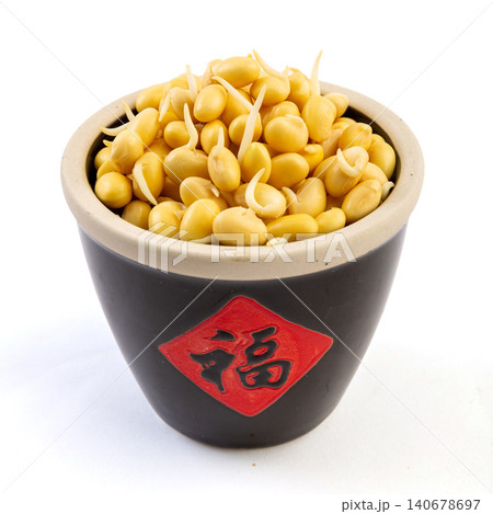 germinated yellow soybeans with tiny sprouts in a black bowl isolated on white background 140678697