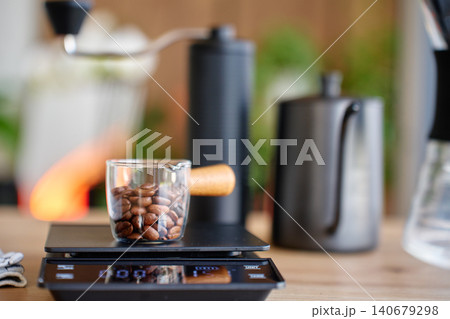 Coffee beans on scale for morning coffee Coffee beans on scale for morning coffee 140679298