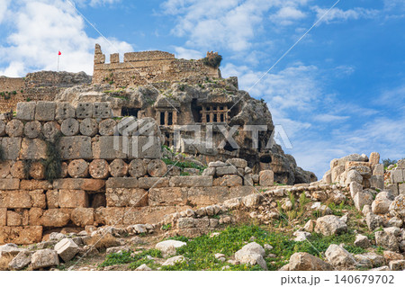 Acropolis, carved in rock tombs of ancient Greek city Tlos in Lycia located on Lycian way. Famous historical site In Antalya region. Popular place for family travel on summer vacation. Fethiye, Turkey 140679702