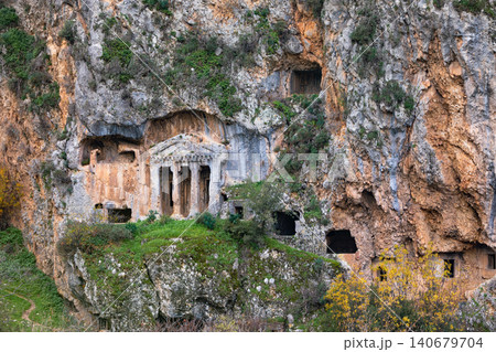Acropolis, tombs carved in rock of ancient Greek city Tlos in Lycia located on Lycian way. Famous historical site In Antalya region. Popular place for family travel on summer vacation. Fethiye, Turkey Acropolis, tombs carved in rock of ancient Greek city Tlos in Lycia located on Lycian way. Famous historical site In Antalya region. Popular place for family travel on summer vacation. Fethiye, Turkey 140679704