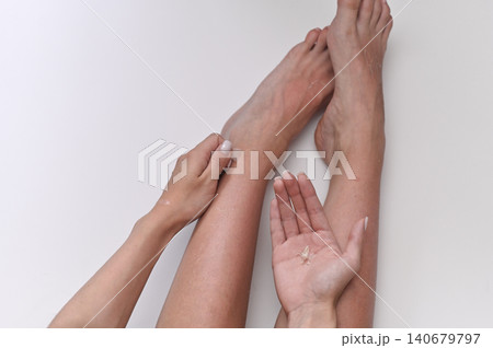 Detailed demonstration of peeling skin removal from sun-damaged feet, highlighting natural recovery process and importance of sun protection. 140679797