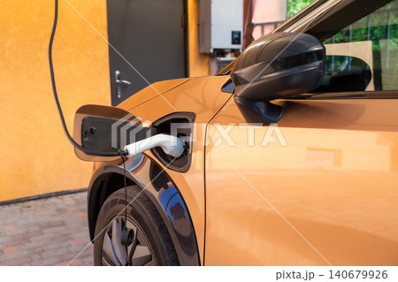 Electric car charging at home residential charging station Electric car charging at home residential charging station 140679926