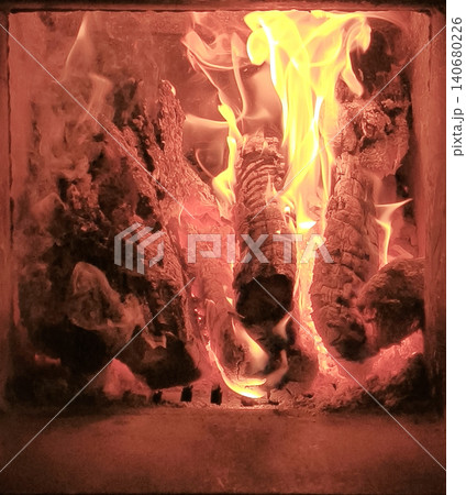 Fire burns in cozy fireplace. 140680226